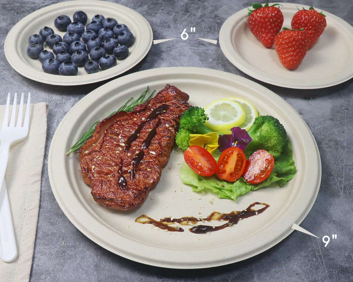 Comparison of two paper plates with a steak and salad on one, and berries and strawberries on the other, on a gray surface.
