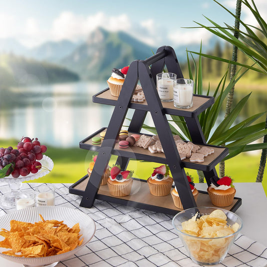 Three-tiered serving tray with snacks and drinks against a scenic background